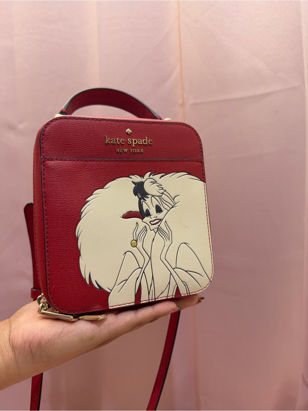 kate spade red and cream Cruella-themed crossbody bag